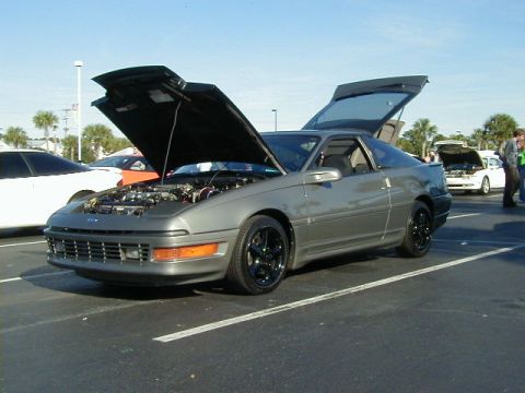 1994 Ford Probe - This gray coupe has its hood and trunk open, revealing the engine compartment and rear storage area.