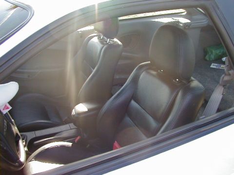1994 Ford Probe - Interior of a 1994 Ford Probe, black leather seats and a view of the back.