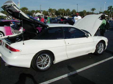 1994 Ford Probe - A white Ford Probe is displayed with its hood and trunk open at an outdoor event.