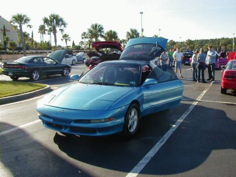 1994 Ford Probe - A blue 1994 Ford Probe is displayed with its doors and hood open at an outdoor car gathering.
