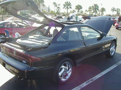 1994 Ford Probe - Black 1994 Ford Probe with its hatchback and hood open, parked outdoors.