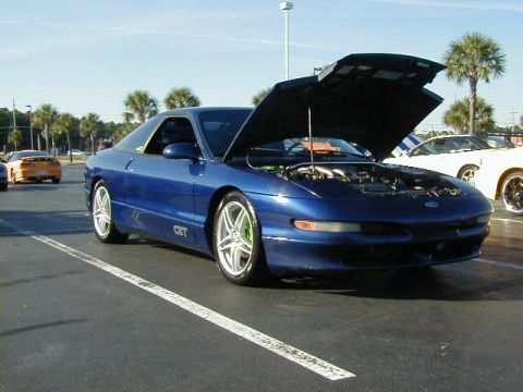 1994 Ford Probe - Blue 1994 Ford Probe GT parked in a lot with its hood open, revealing the engine bay.