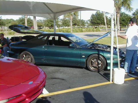 1994 Ford Probe - A green 1994 Ford Probe is displayed with its hood open, parked next to another vehicle.