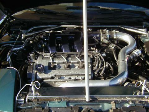 1994 Ford Probe - The engine bay of a 1994 Ford Probe, a V6 engine with custom modifications.