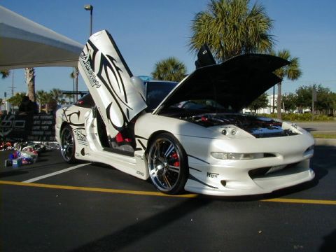 1994 Ford Probe - This customized 1994 Ford Probe features butterfly doors and an open hood revealing the engine bay.