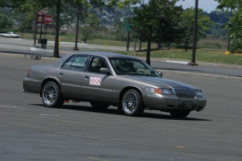 2001 Mercury Grand Marquis - A Mercury Grand Marquis participates in an autocross event on a paved course.