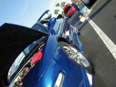 1994 Ford Probe - A blue 1994 Ford Probe is displayed with its hood open, showing off its engine bay.