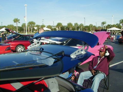 1994 Ford Probe - Several cars are parked with their hoods open, including a 1994 Ford Probe with a prominent blue spoiler.