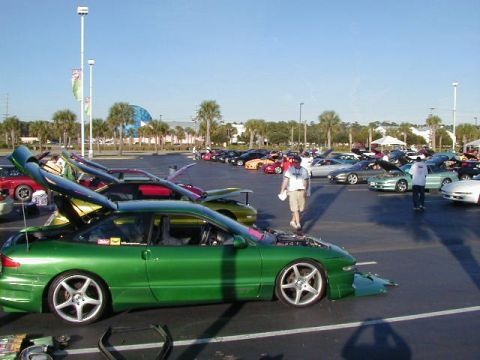 1994 Ford Probe - A green 1994 Ford Probe is displayed with its hood and trunk open at an outdoor car event.