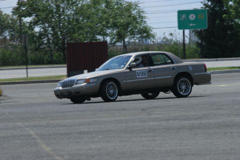 2001 Mercury Grand Marquis - A Mercury Grand Marquis participates in an autocross event, showing its racing number on the door.