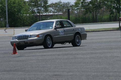 2001 Mercury Grand Marquis - A tan 2001 Mercury Grand Marquis navigates a course, displaying racing number 888 on its door.