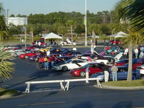 1994 Ford Probe - A gathering of sports cars at an outdoor event, with people milling around.