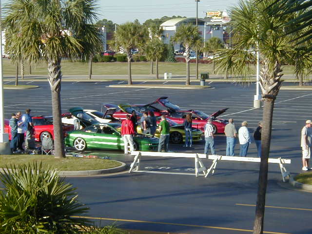 Green 1994 Ford Probe with white racing stripes, 3/4 front view