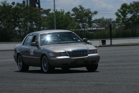 2001 Mercury Grand Marquis - A 2001 Mercury Grand Marquis sedan is seen from the front-right quarter angle on an asphalt surface.