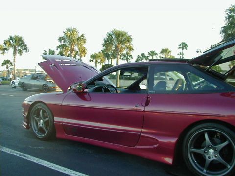 1994 Ford Probe - A red 1994 Ford Probe is shown with its hood and trunk open, parked outdoors with other vehicles visible.