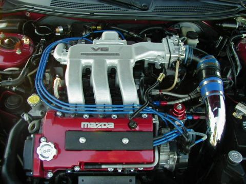 1994 Ford Probe - Close-up of a modified Mazda V6 engine, showing intake and ignition components.