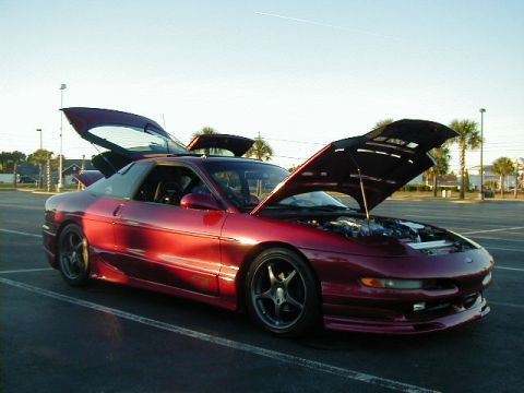 1994 Ford Probe - A red coupe, possibly a 1995 model, is shown with its hood and trunk open in a parking lot.