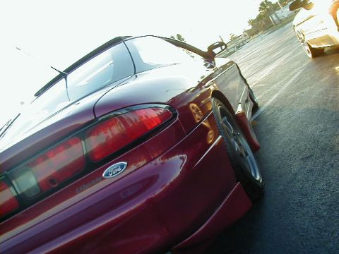 1994 Ford Probe - Rear view of a red 1994 Ford Probe, showing its distinctive taillights and Ford badging.