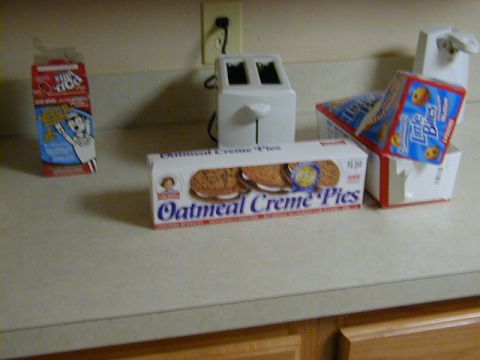 1994 Ford Probe - A countertop scene snacks and a toaster, with a box of Oatmeal Creme Pies prominently displayed.