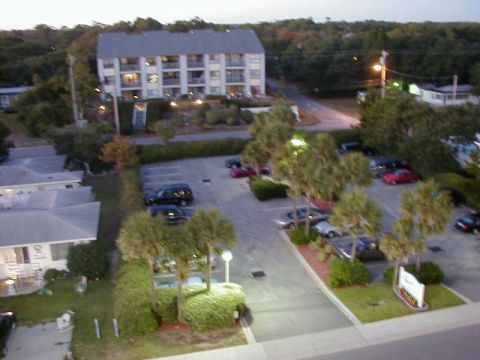 1994 Ford Probe - A view of a parking lot and buildings, with several vehicles parked.