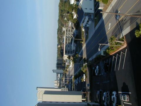 1994 Ford Probe - A view of a coastal town with buildings and a parking lot filled with vehicles.