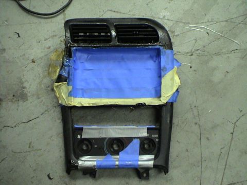 1997 Ford Probe - Center console part with air vents and climate controls, taped for modification.
