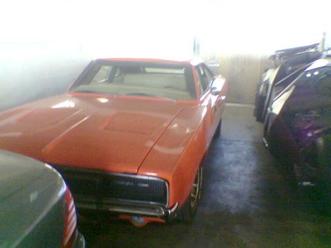 1988 Ford Bronco - This orange muscle car appears to be a 1970 Dodge Charger R/T, not a 1988 Ford Bronco.