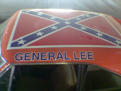 1988 Ford Bronco - The roof of a car displays the Confederate flag and the text "GENERAL LEE".