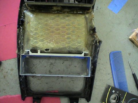 1997 Ford Probe - A disassembled vehicle center console part is shown, with visible texture and a blue-lined opening.
