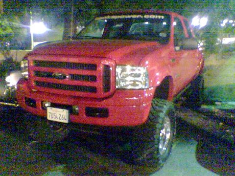 1988 Ford Bronco - This red pickup truck is shown from the front, displaying its license plate.