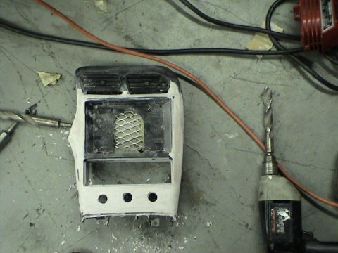 1997 Ford Probe - A car's center console is being modified, with tools and wires visible in the background.