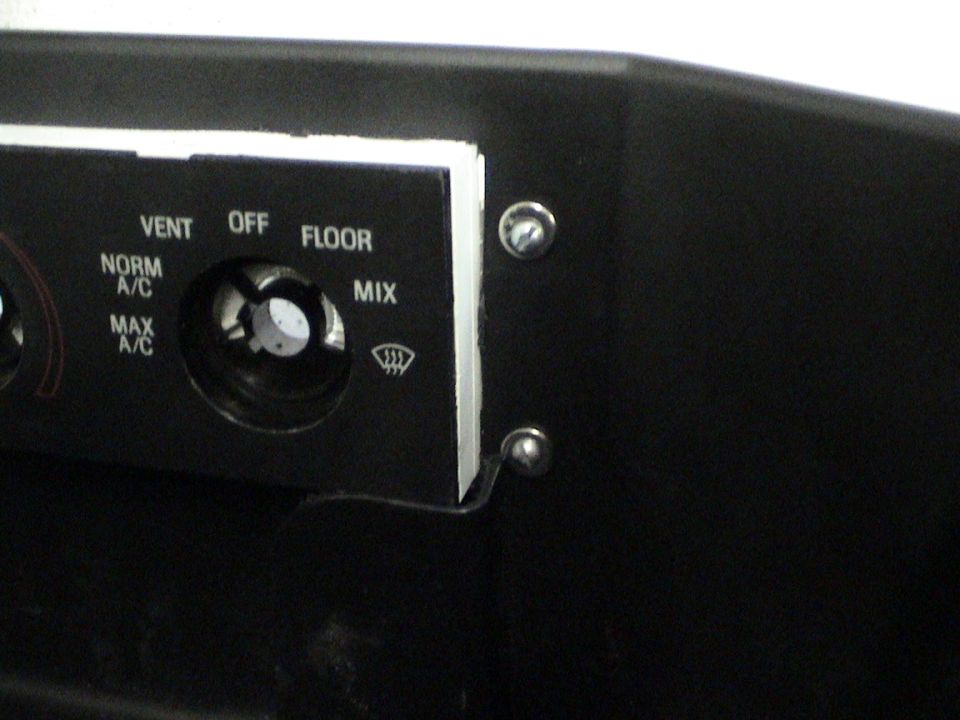 Close-up of car climate controls with labels for VENT, OFF, FLOOR, NORM A/C, MAX A/C, and MIX