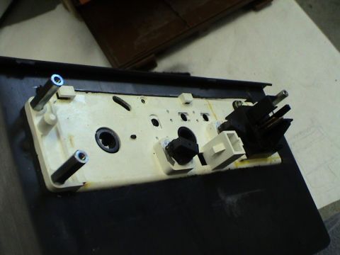 1997 Ford Probe - Close-up view of the rear of a disassembled car interior component, showing wiring connections.