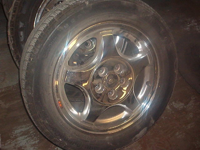 Chrome wheel with five spokes and a black tire
