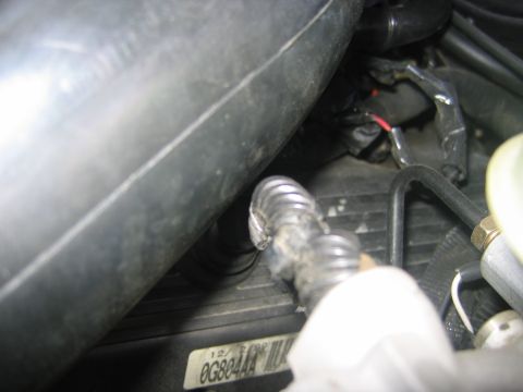 2000 Ford Crown Victoria - Engine bay detail with visible wiring, hoses, and a part number label.