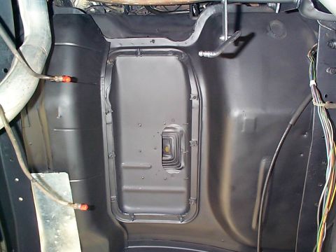 1979 Ford Bronco - Underside view of a vehicle's floor pan, showing structural details and some wiring.
