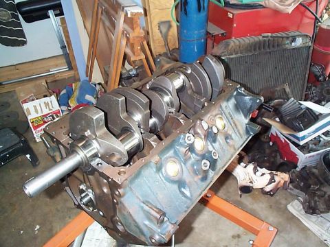 1979 Ford Bronco - Engine block and crankshaft assembly on an engine stand in a workshop setting.