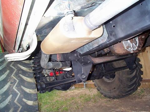 1979 Ford Bronco - The undercarriage of a vehicle is visible, including the exhaust system and suspension components.