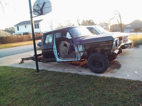 1979 Ford Bronco - This Ford Bronco body is missing its front end and doors, sitting next to another vehicle.