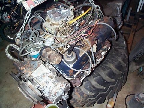 1979 Ford Bronco - This image shows an engine and a large tire, likely from a truck or industrial equipment, not a 1979 Ford Bronco.