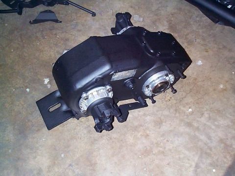 1979 Ford Bronco - This is a close-up view of a black NP205 transfer case, likely removed from a vehicle for repair or replacement.