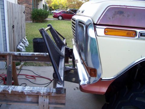 1979 Ford Bronco - Custom bumper attachment is being fitted to the front of a vintage Ford truck.