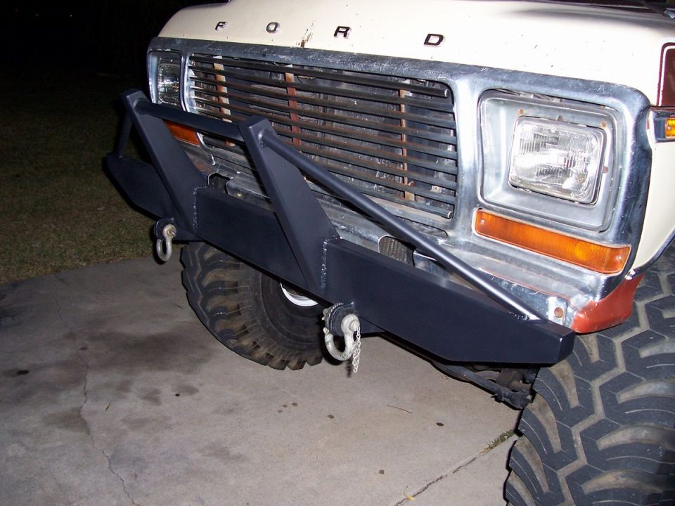 Ford truck front with aftermarket bumper and large tires