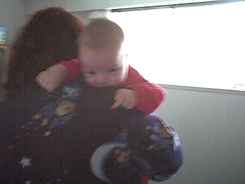 1989 Ford Bronco - A baby is held up, looking towards the camera, with a bright window in the background.