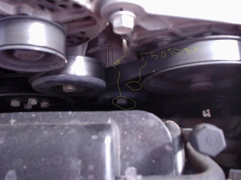 2000 Ford Taurus - Close-up view of engine belt and pulleys, with handwritten markings indicating T50 torque and a 15mm measurement.