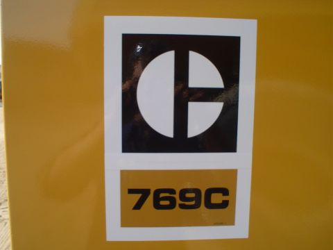 1966 International School Bus - This image shows the Caterpillar logo and model number 769C on a yellow surface.
