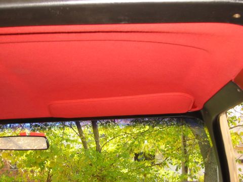 1990 Ford Bronco - View from inside a vehicle, showing the red headliner and a portion of the windshield.