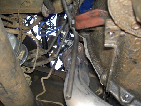 1988 Ford Bronco - Close-up view of vehicle engine components, showing exhaust piping and various wires.