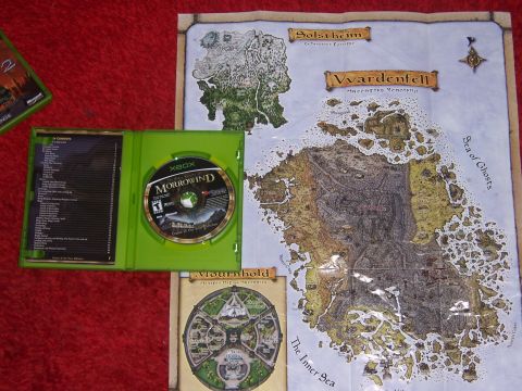 1997 Ford Probe - The image displays the Xbox game Morrowind, its case, and several maps related to the game's world.