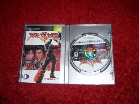 1997 Ford Probe - The image shows an open Xbox game case for Soul Calibur II, with the disc and manual visible.